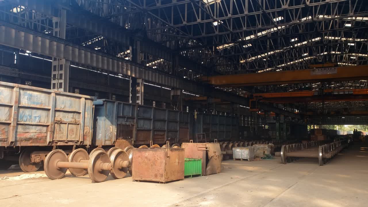 This video captures a lively workshop where Indian Railways trains are actively maintained and repaired, highlighting many workers and various equipmen