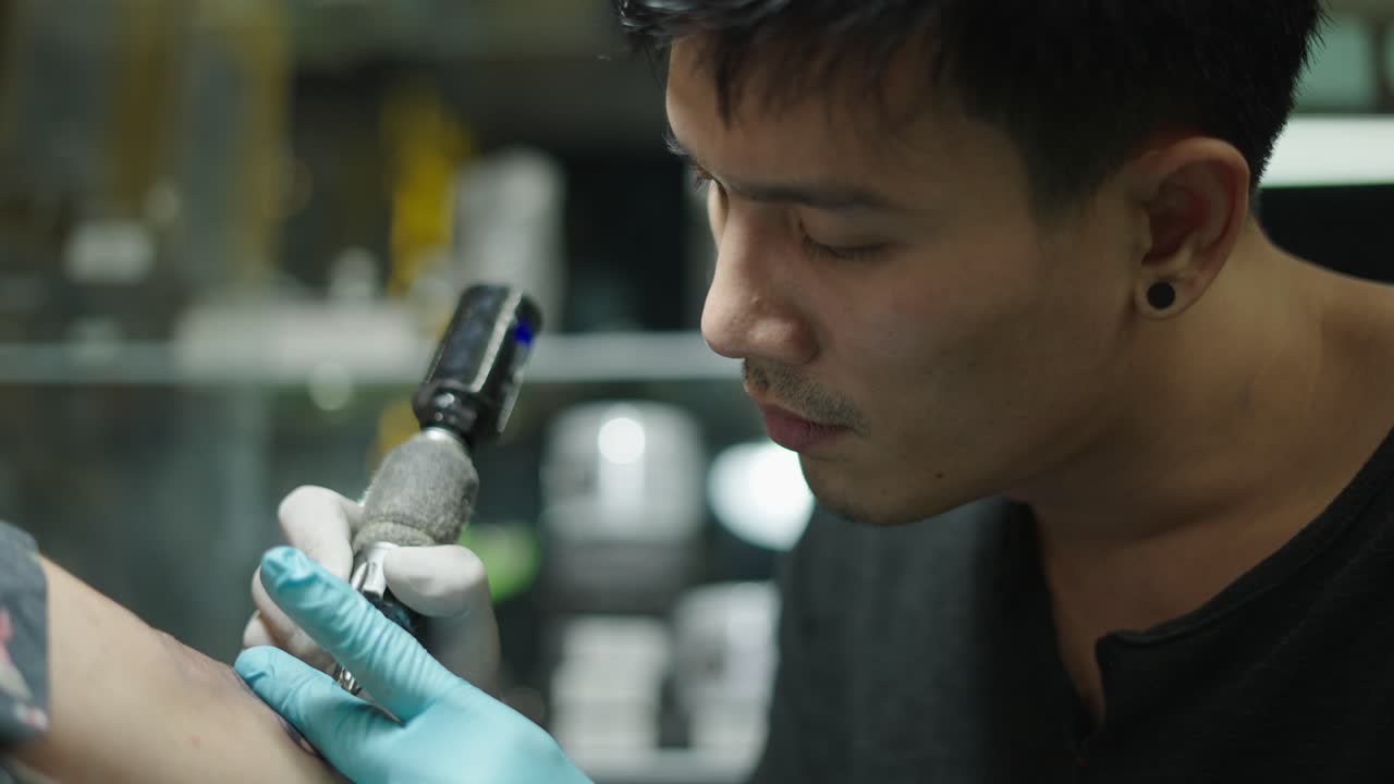 Tattoo artist performing a tattoo