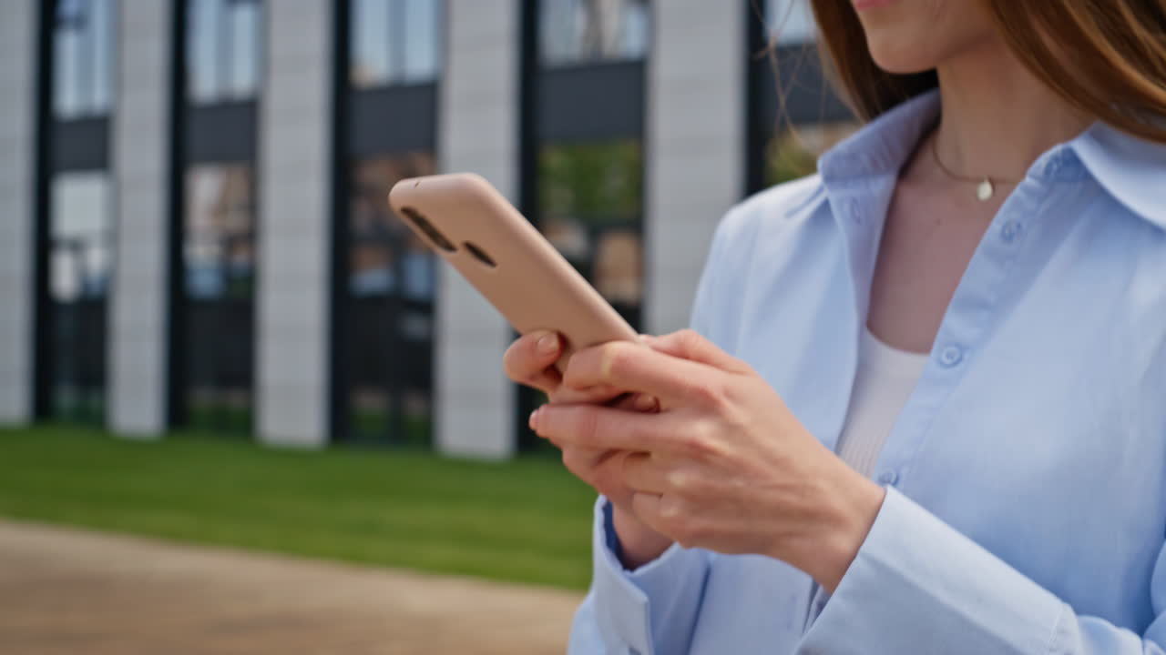 Elegant businesswoman texting cellphone walking business district closeup
