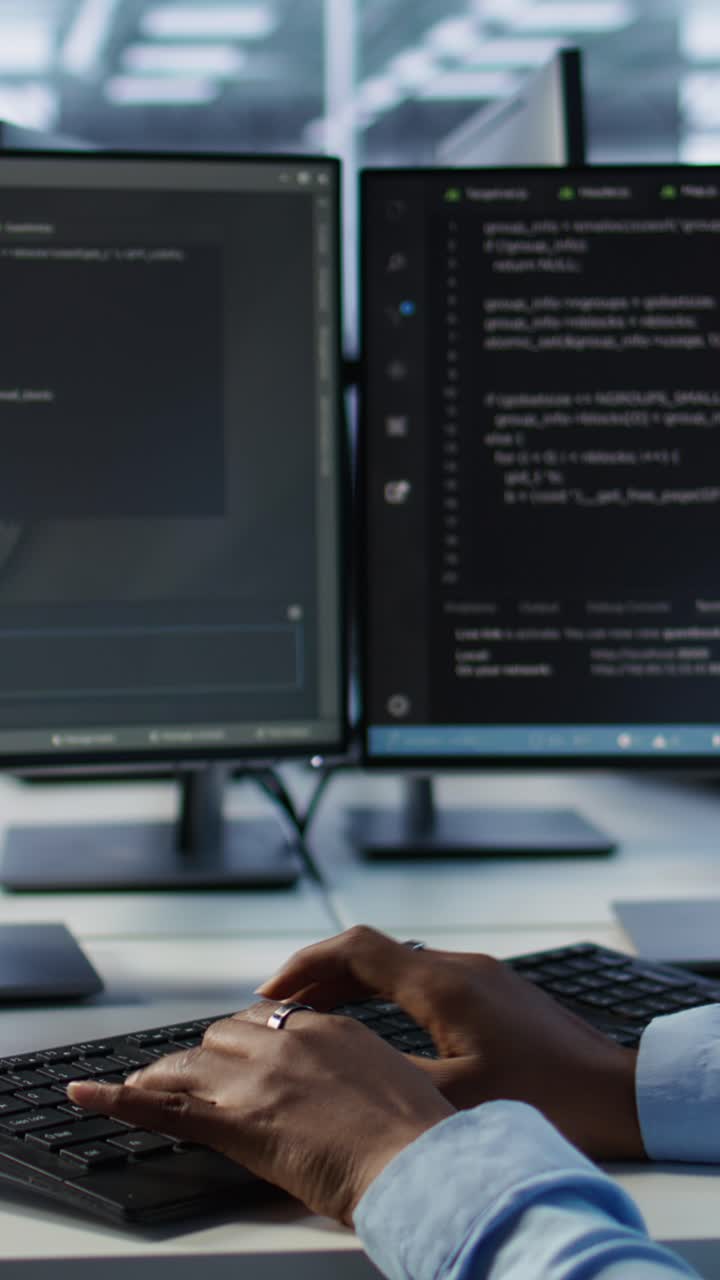 Hands Typing Code on Computer Keyboard in Modern Office