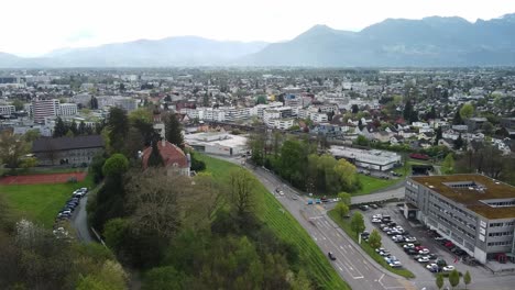 industrial-town-in-the-alps,-mountain-town,-hills-green