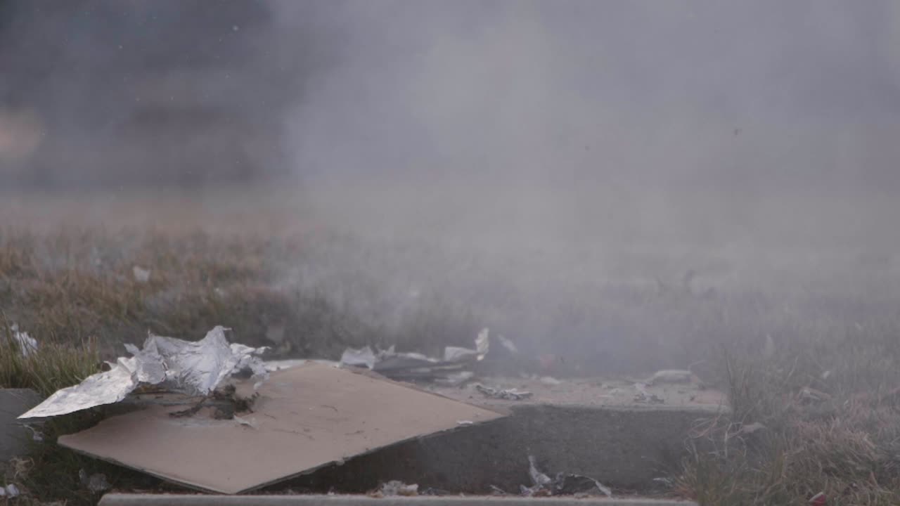 A Christmas ginger bread and graham cracker decoration has a large fire cracker or M 80 lit on it as it burns if finally explodes in slow motion!