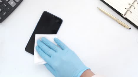 cleaning a smartphone with gloves