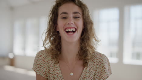 portrait of happy young woman student laughing looking at camera enjoying independent lifestyle  beautiful female relaxed carefree in apartment background