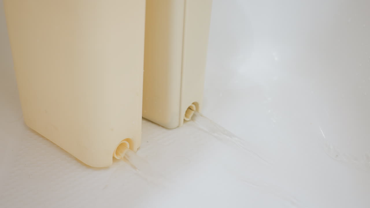 Close up of hand adjusting bucket seal on wet surface to prevent water leakage, focusing on home care, cleaning, and maintenance task ensuring proper sealing for protection against spills