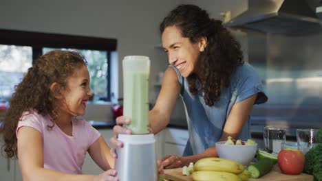 Mixed-race-mother-and-daughter-cooking-together-in-the-kitchen