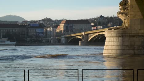 slow motion shot of huge waves on danube river during flooding at margaret bridge, budapest, hungary