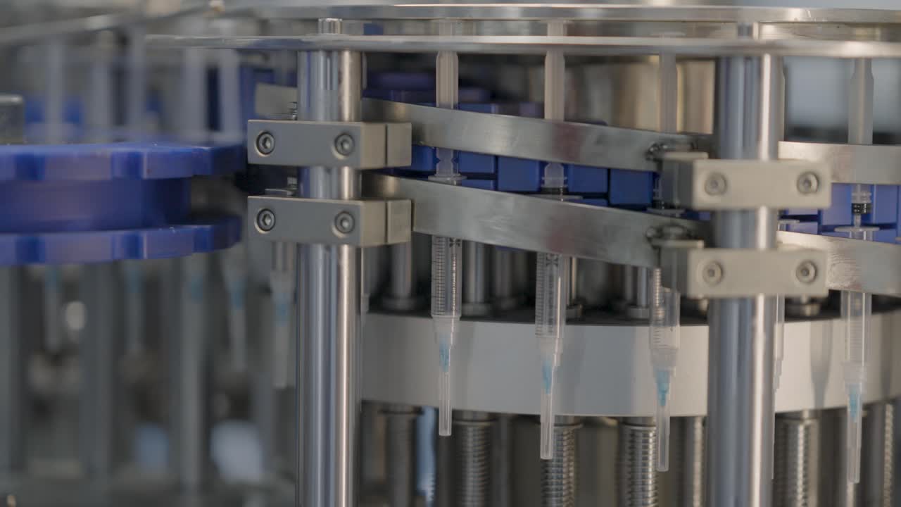 Medical Syringes Being Filled In A Production Plant By An Automated Pharmaceutical Machine, Close Up Shot