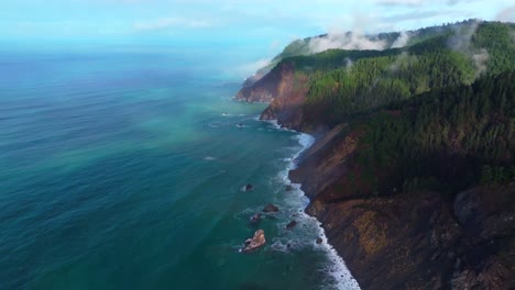 pnw lost coast trail rugged dramatic untouched coastline aerial drone california surf waves boulder rocks usal beach campground cloudy shaded mist fog sun rays morning nature landscape forward