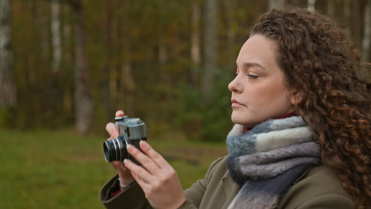 Woman with vintage camera in nature