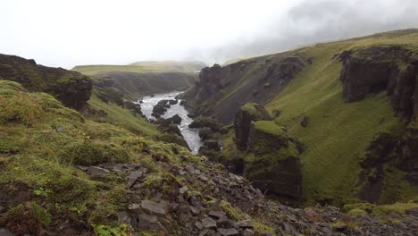 skóga river between the hestavaðsfoss and fosstorfufoss waterfalls along the laugavegur trail on a rainy misty day - iceland