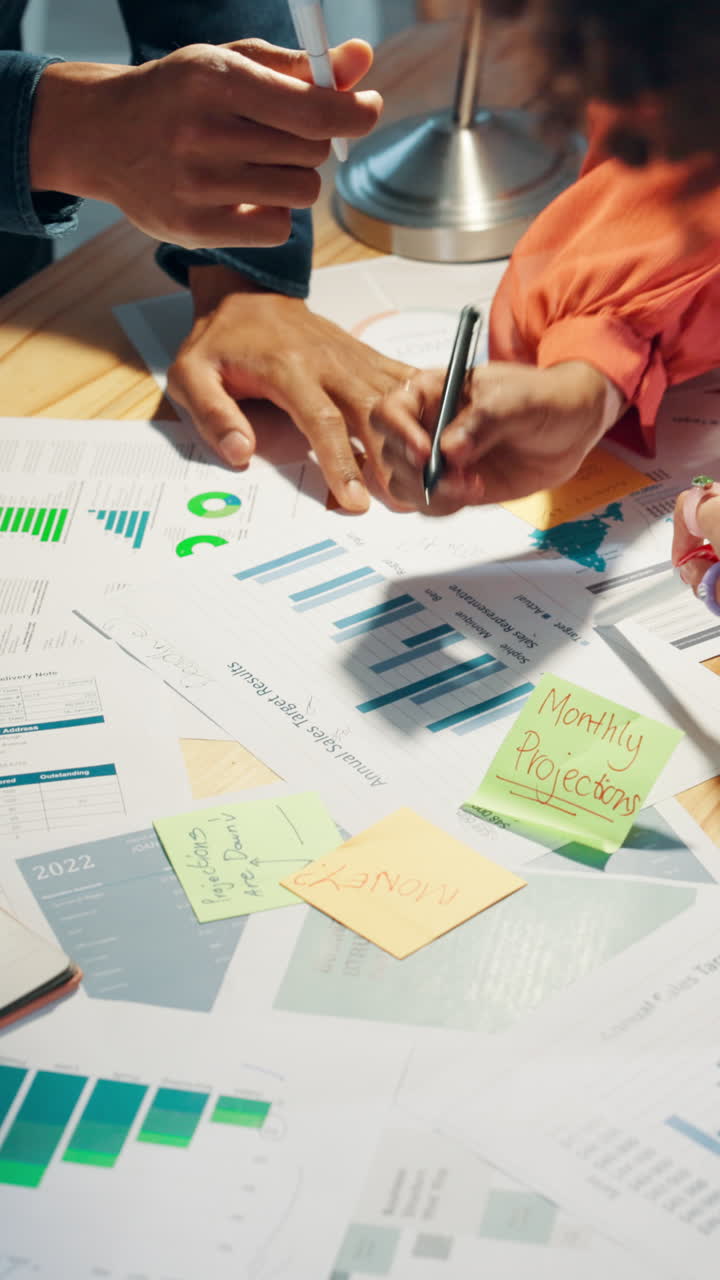Close-up of Business Team Collaborating on Financial Documents and Charts