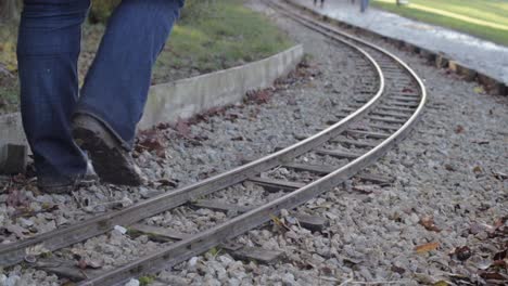 person walking alongside monorail train track