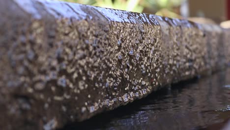 steady shot of water trickling down a concrete slab