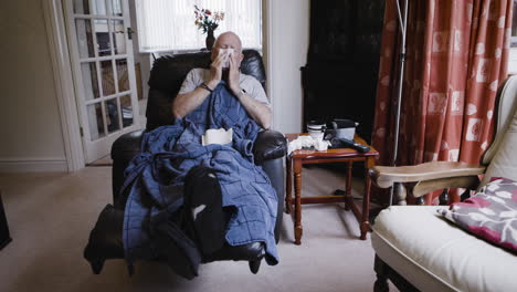 man with cold sitting in chair