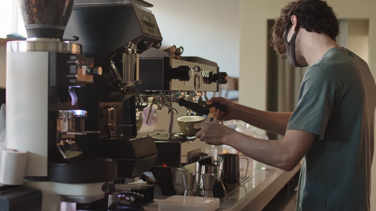 Male Barista Making Coffee Using Coffee Machine