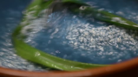 preparing nasi kerabu or blue rice - traditional malaysian dish