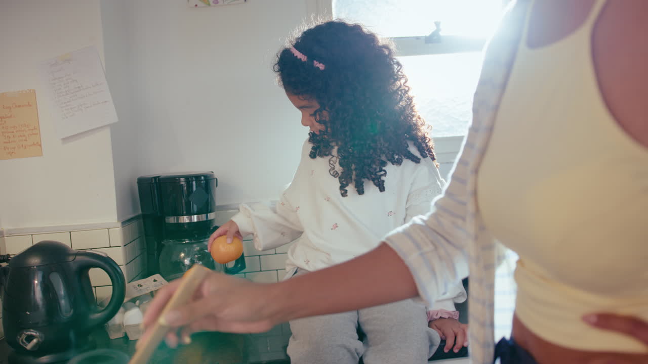 Little Girl Having Fun when Mom Cooking Dinner