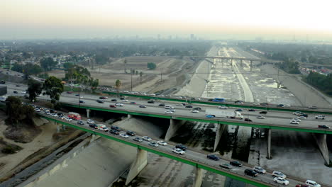 aerial view of busy freeways and concrete river channel in an urban landscape