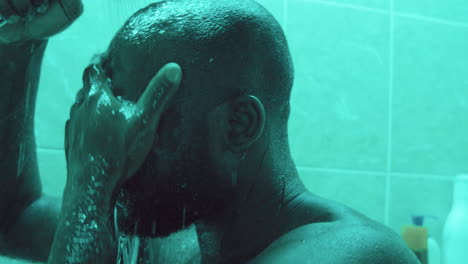 african american man taking shower in bathroom