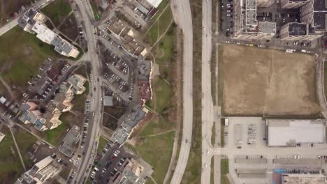 flying over a concrete living apartment area in east europa with many birds flying around the drone