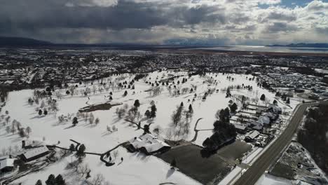 drone shot panning over snow covered town until it rests over a beautiful view