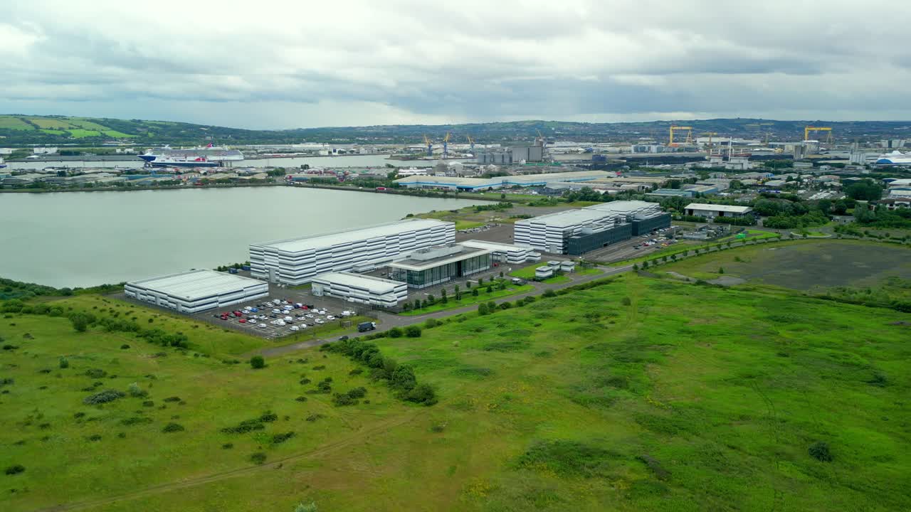 Wide rotating aerial video GV of Studio Ulster, a virtual production film studio in Belfast, Northern Ireland. Filmed in 4K, 30FPS and with Rec709 color