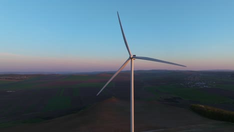 A-wind-turbine-spinning-in-the-countryside-at-dusk