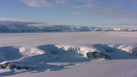 expansive icy landscape with distant mountains