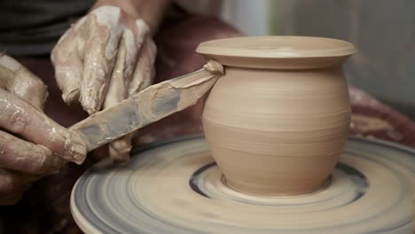 the potter makes a jug of clay. ceramist. a man makes a vase on a potter's wheel