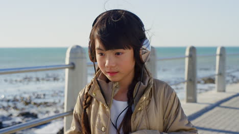 travel, little girl and headphones music at beach