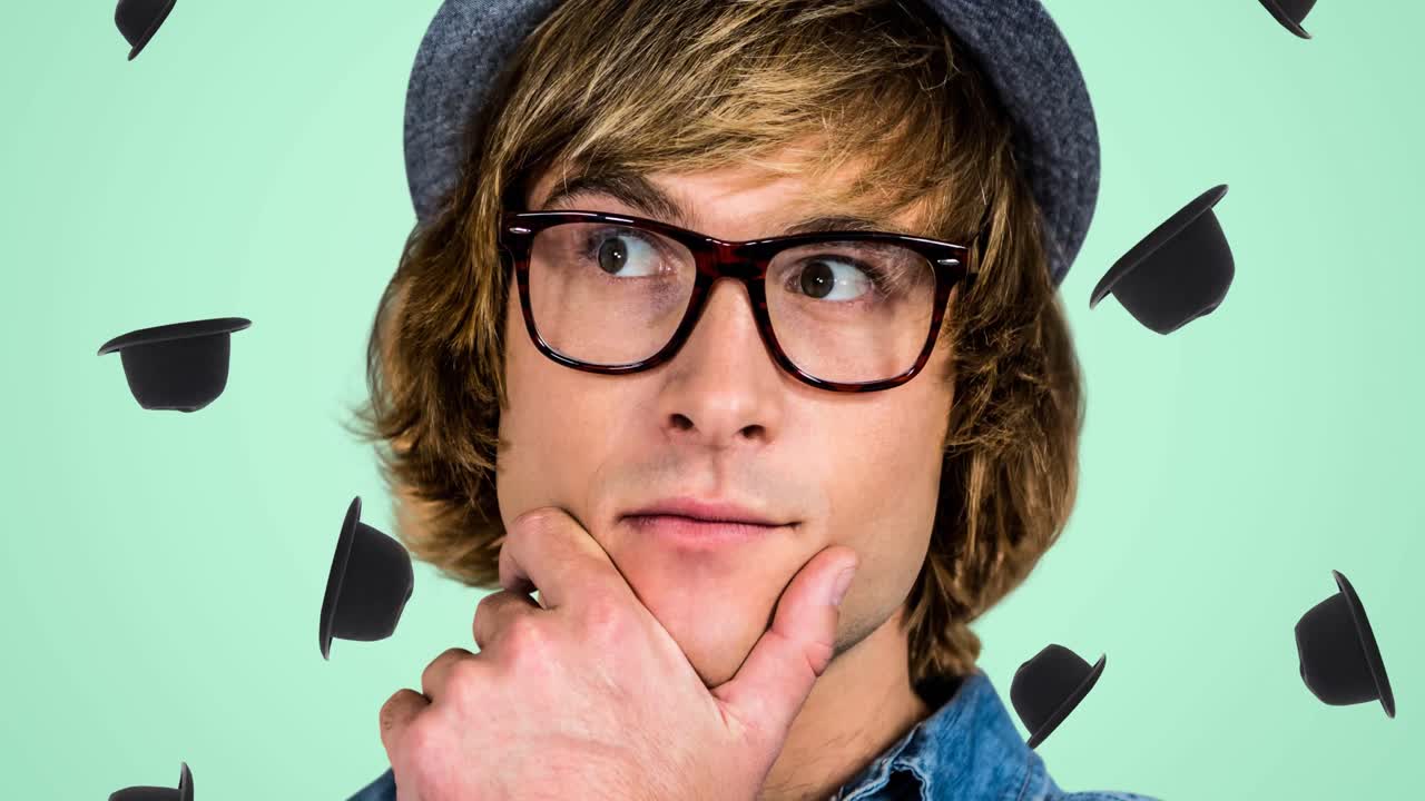 animación de un hombre caucásico con sombrero y gafas sobre sombreros caídos sobre fondo verde