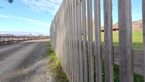 curved gravel path beside a wooden fence