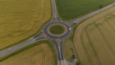 beautiful aerial view of large roundabout with green fields surrounding it