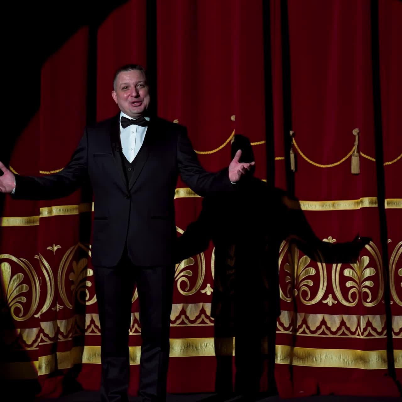 Senior man in costume on stage in darkness. Actor man in selective light on stage during the performance in the theater