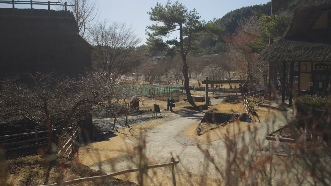 Inside a traditional Japanese village, young man walks by, Saiko, Japan
