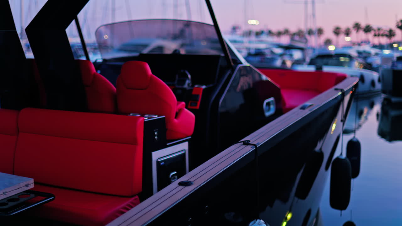 Black and red boat docked in the Port Vauban at sunset in Antibes, France