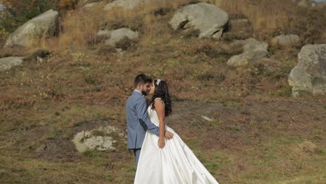 Groom-with-bride-near-mountain-hills.-Wedding-couple.-Happy-family-in-love