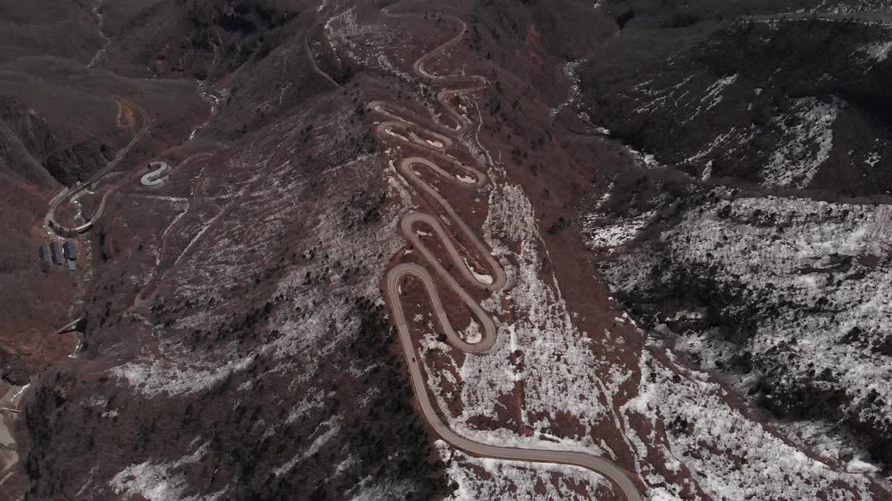 Aerial Fly Over Zigzag Road Through Arid Mount Zao Volcanic Landscape, Japan