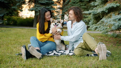 couple and their dog enjoying a picnic in the park