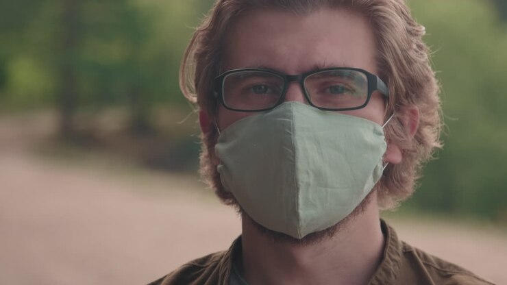 Close-Up Of Man Outdoors In Cotton face Mask