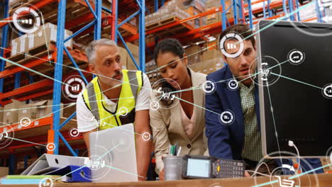 animation of network of connections with icons over diverse workers using computer in warehouse