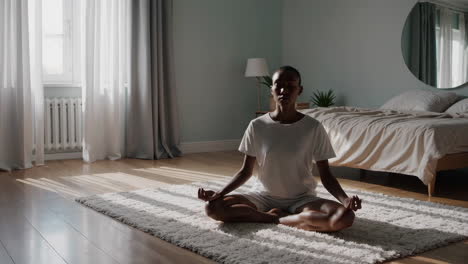 woman meditating in a bedroom