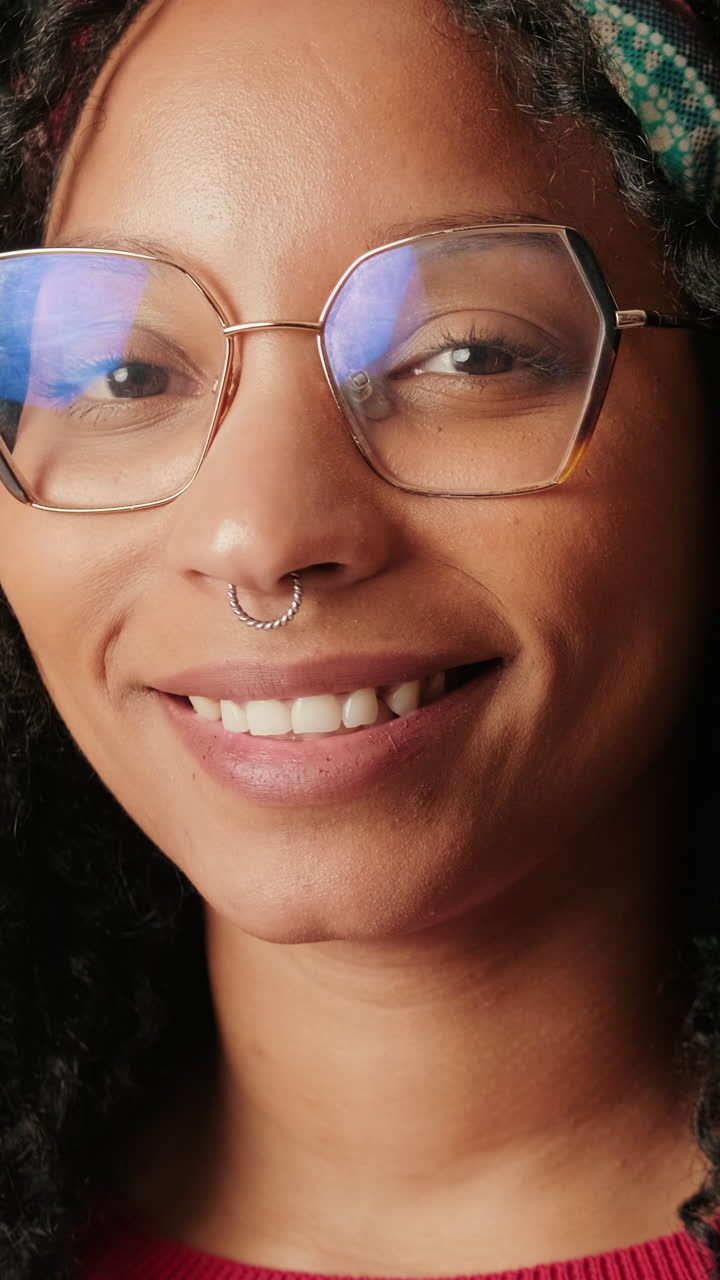 Close Up Portrait of Young Woman with Glasses Smiling at Camera
