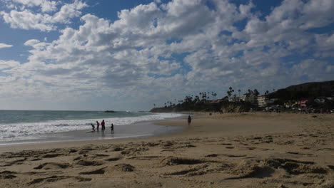 beautiful clouds in the beach, california beach day, clouds moving fast in the beach, people in the beach.