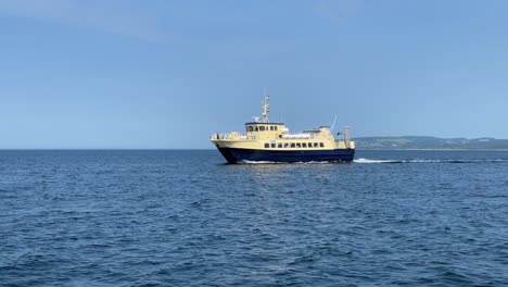yellow ferry boat sailing on calm ocean water