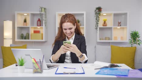 home office worker woman rejoicing on the phone.