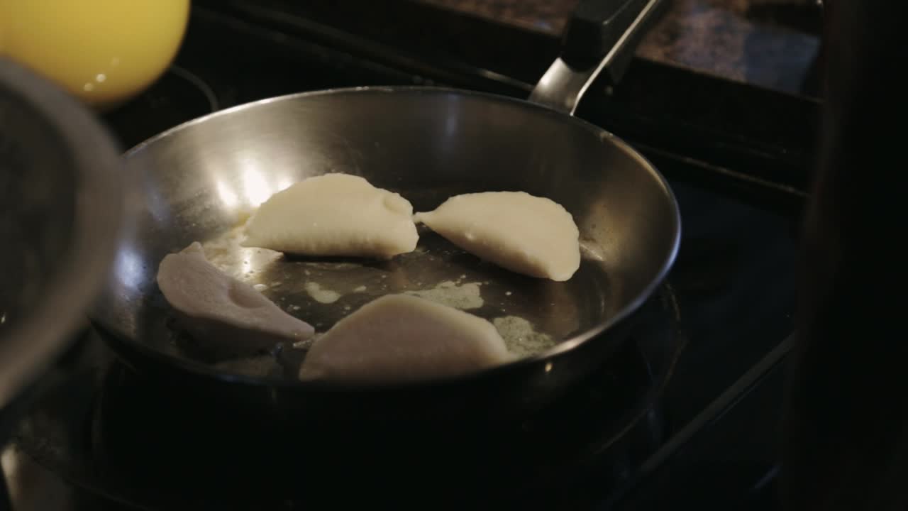 Canada - Chef Putting Delicious Dumplings In Stainless Pan For Cooking - Closeup Shot