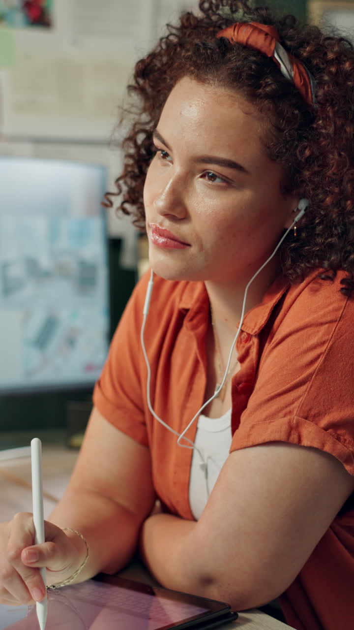 Young Woman with Curly Hair Drawing on Tablet with Stylus