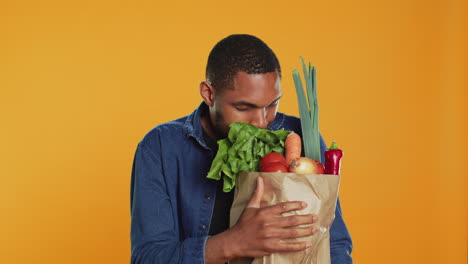 Vegan-person-enjoying-the-fresh-ripe-natural-aroma-of-groceries